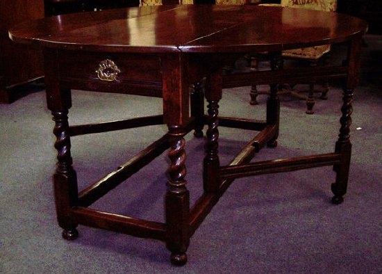 Appraisal: A walnut gateleg table circa the re-polished two-flap top on