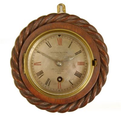 Appraisal: A carved and stained wood wall clock with a cylinder