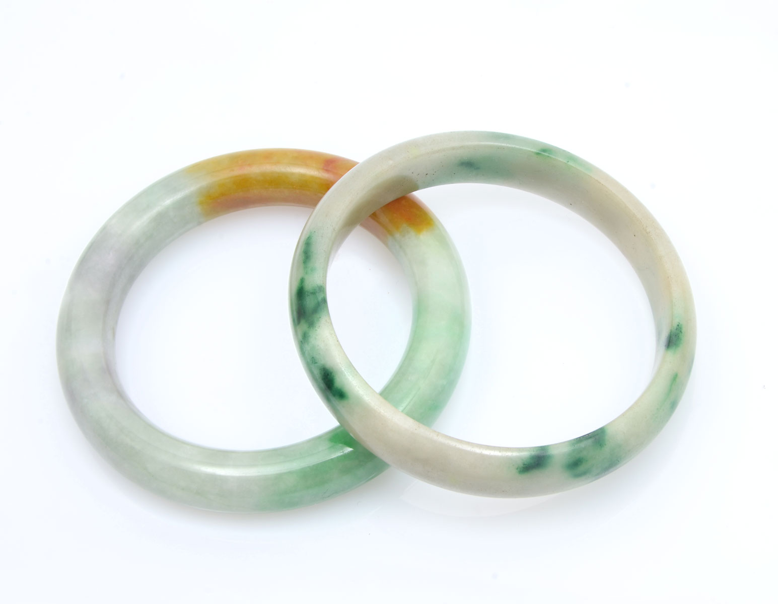 Appraisal: JADE BANGLES bangle is mottled with gold and dark green