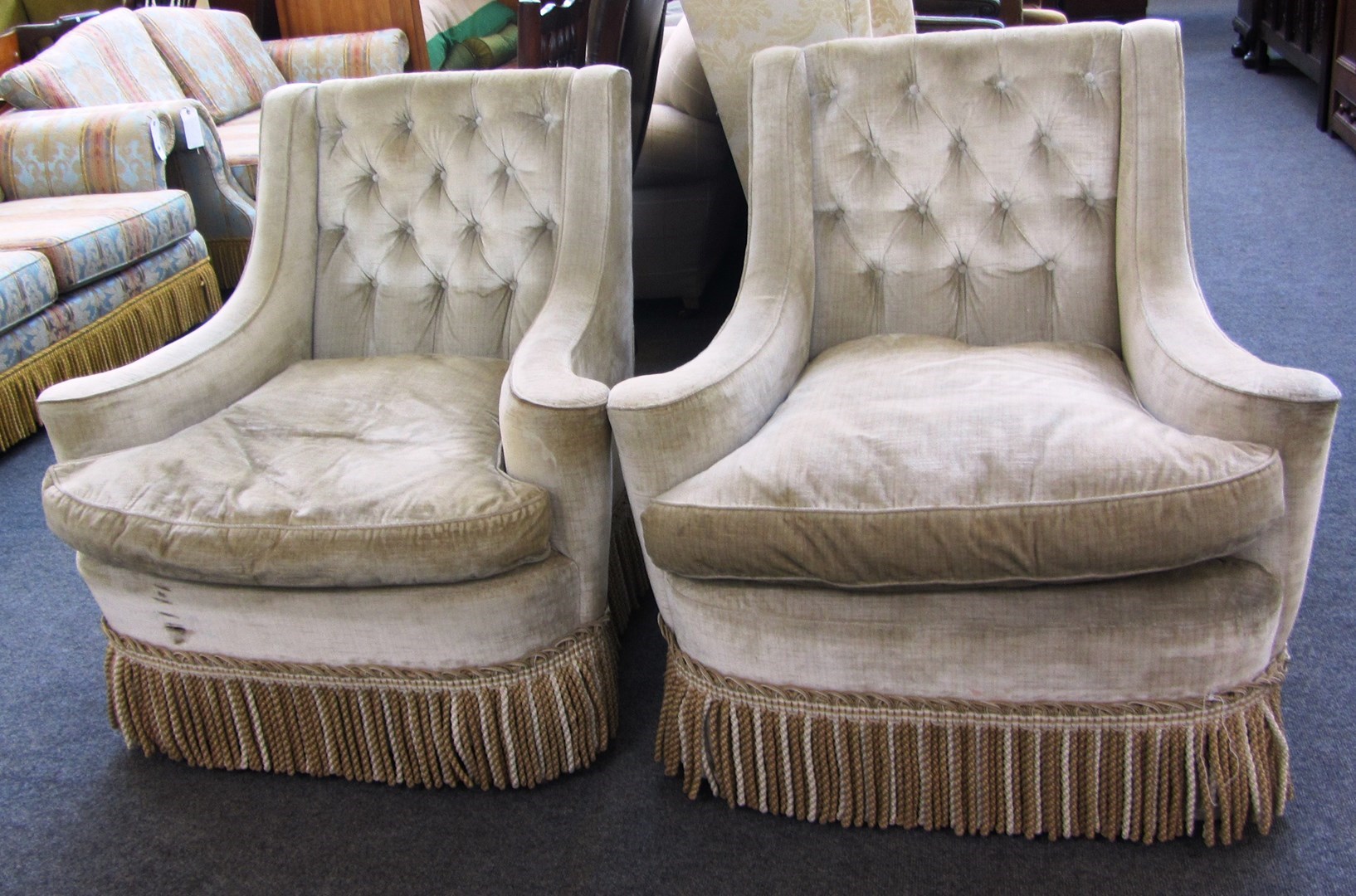 Appraisal: A pair of late th century button back easy armchairs