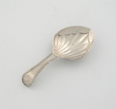 Appraisal: A George III caddy spoon with a bright cut stem