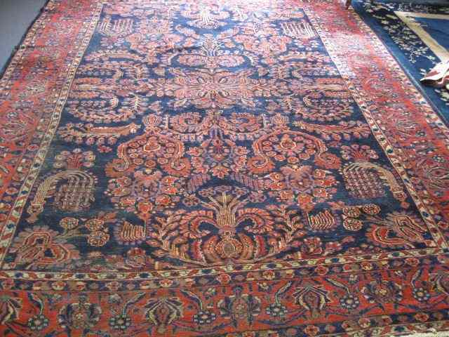 Appraisal: Sarouk Style Persian Handmade Room Sizerug elaborate floral reds blues