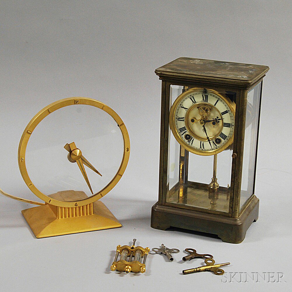 Appraisal: Two Metal Mantel Clocks an Ansonia brass and glass-cased mantel