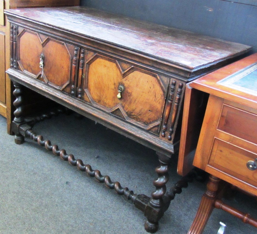 Appraisal: A th century style oak two door side cabinet on