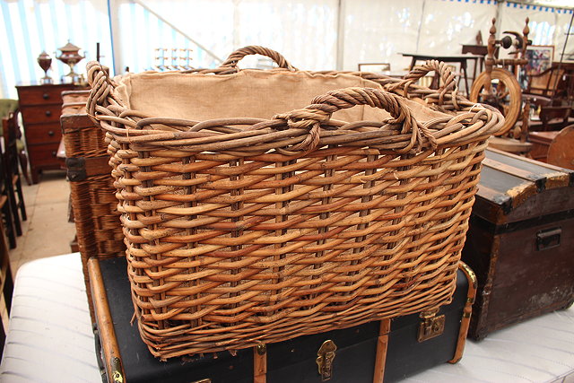 Appraisal: A RECTANGULAR WICKER BASKET with four handles and hessian lined