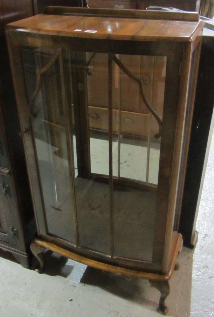 Appraisal: A 's walnut bowfront display cabinet