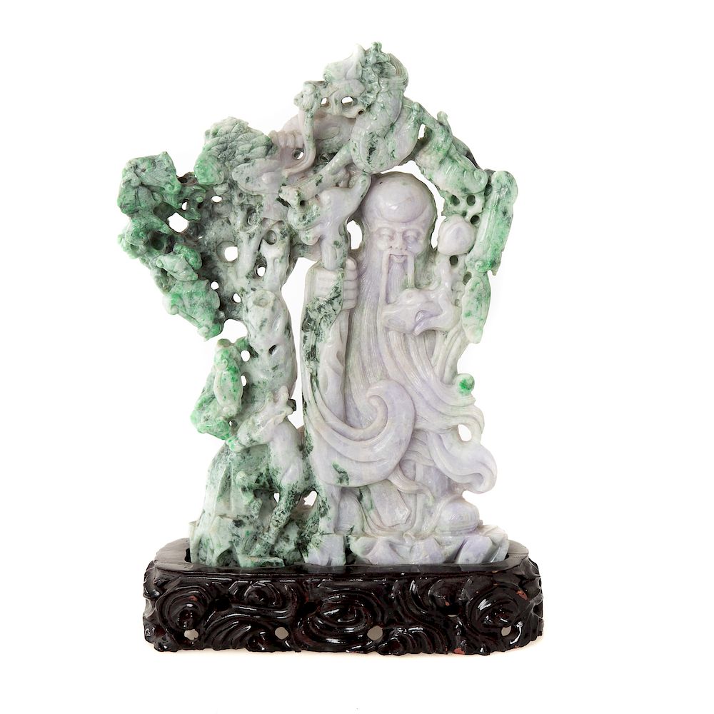 Appraisal: Chinese Carved Jade Immortal figure framed by a flowering tree