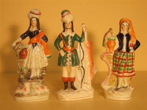 Appraisal: THREE STAFFORDSHIRE FIGURES Late th century including a hunter in