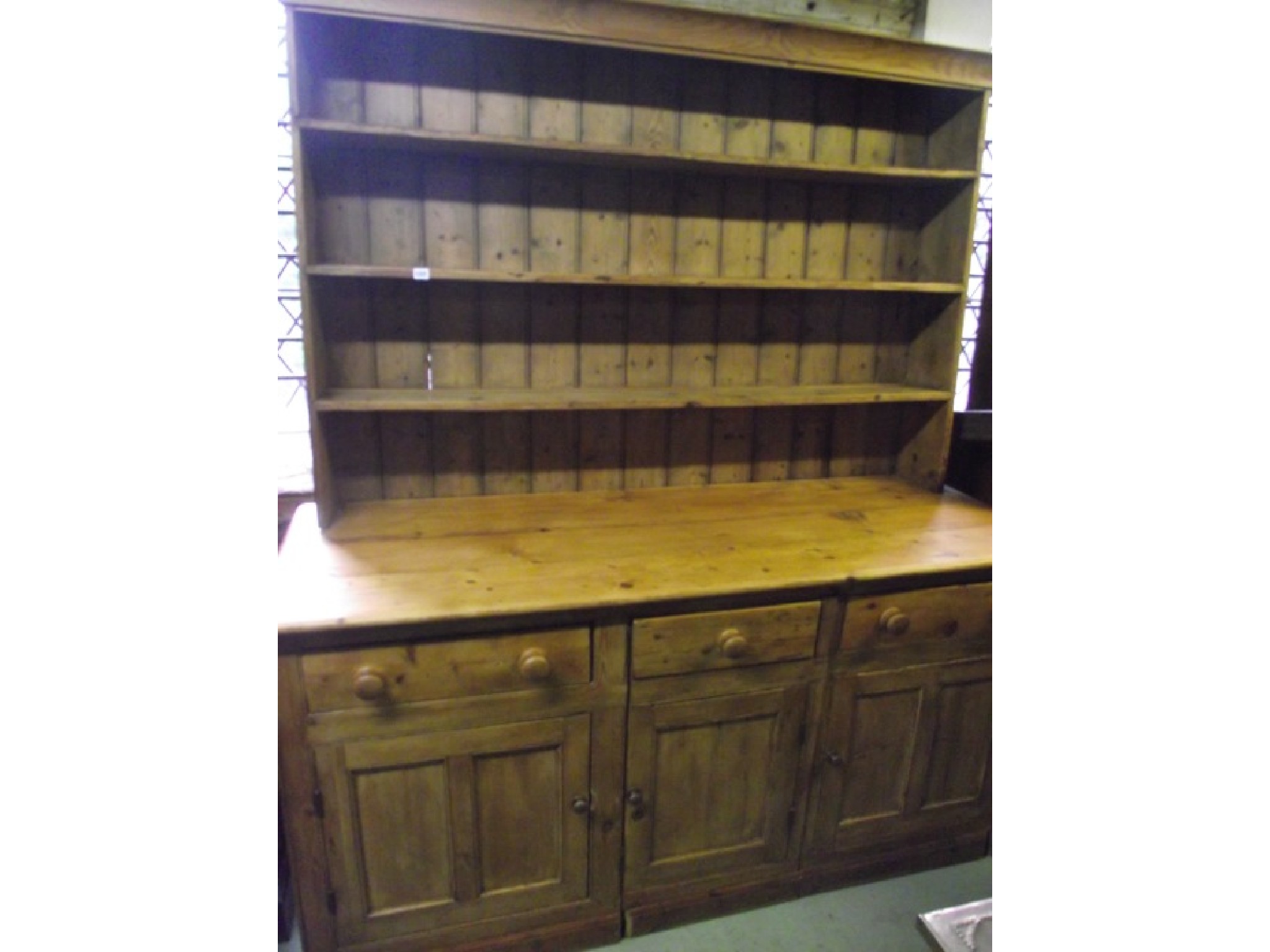 Appraisal: A substantial reclaimed stripped pine kitchen dresser the base presented