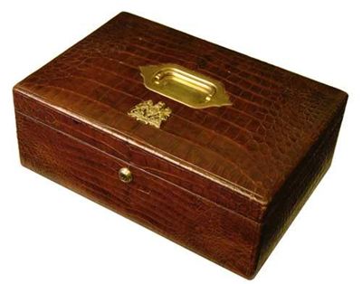 Appraisal: A crocodile dispatch box with a sunken brass handle to