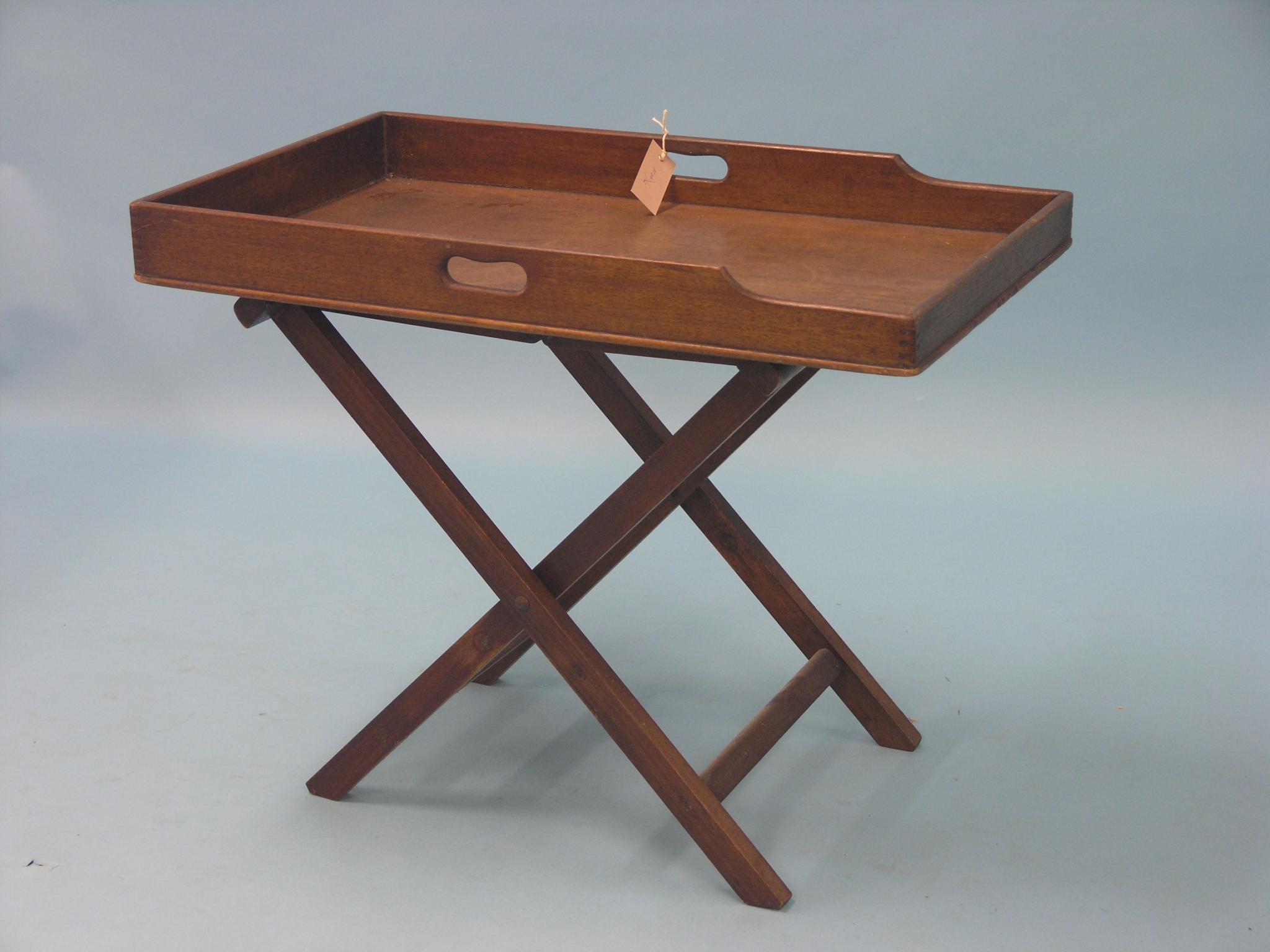 Appraisal: A mahogany butler's tray on folding stand