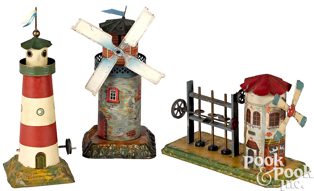 Appraisal: Three windmill and lighthouse steam toy accessories Three painted and