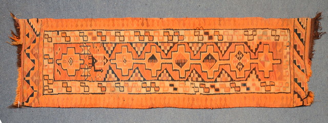 Appraisal: A KURDISH TANGERINE AND BLUE RUNNER within inter-linked central medallion