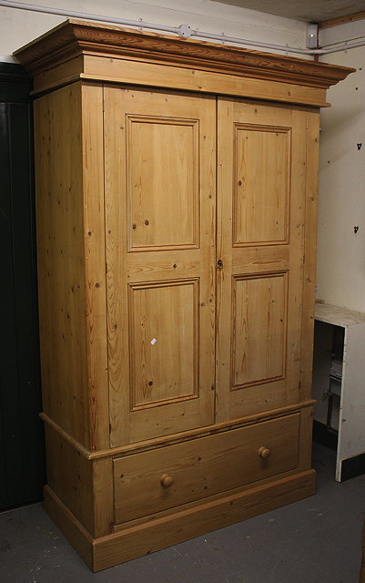 Appraisal: A TH CENTURY PINE WARDROBE with two panelled doors above