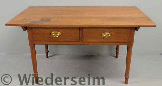 Appraisal: Pennsylvania walnut two-drawer tavern table early th c with turned