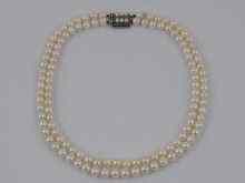 Appraisal: A two row cultured pearl necklace with a silver and