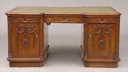 Appraisal: CHIPPENDALE-STYLE CARVED MAHOGANY PARTNER'S DESK The reverse breakfront top with