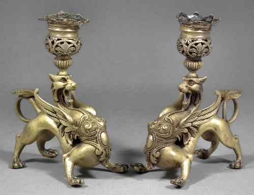 Appraisal: A pair of French gilt brass pillar candlesticks with griffin