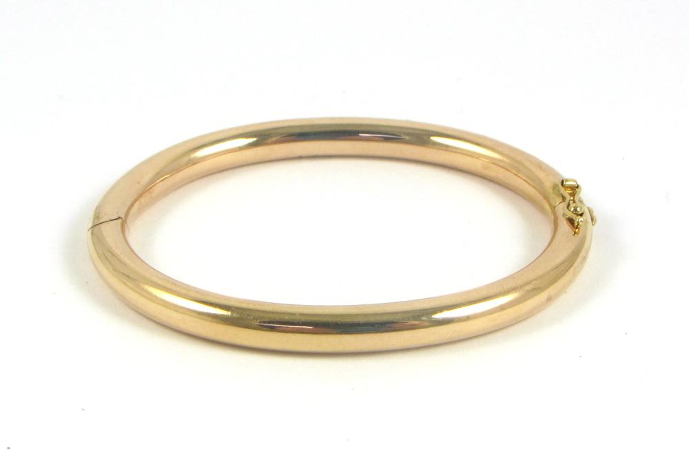 Appraisal: FOURTEEN KARAT ROSE GOLD BANGLE The oval hinged k gold