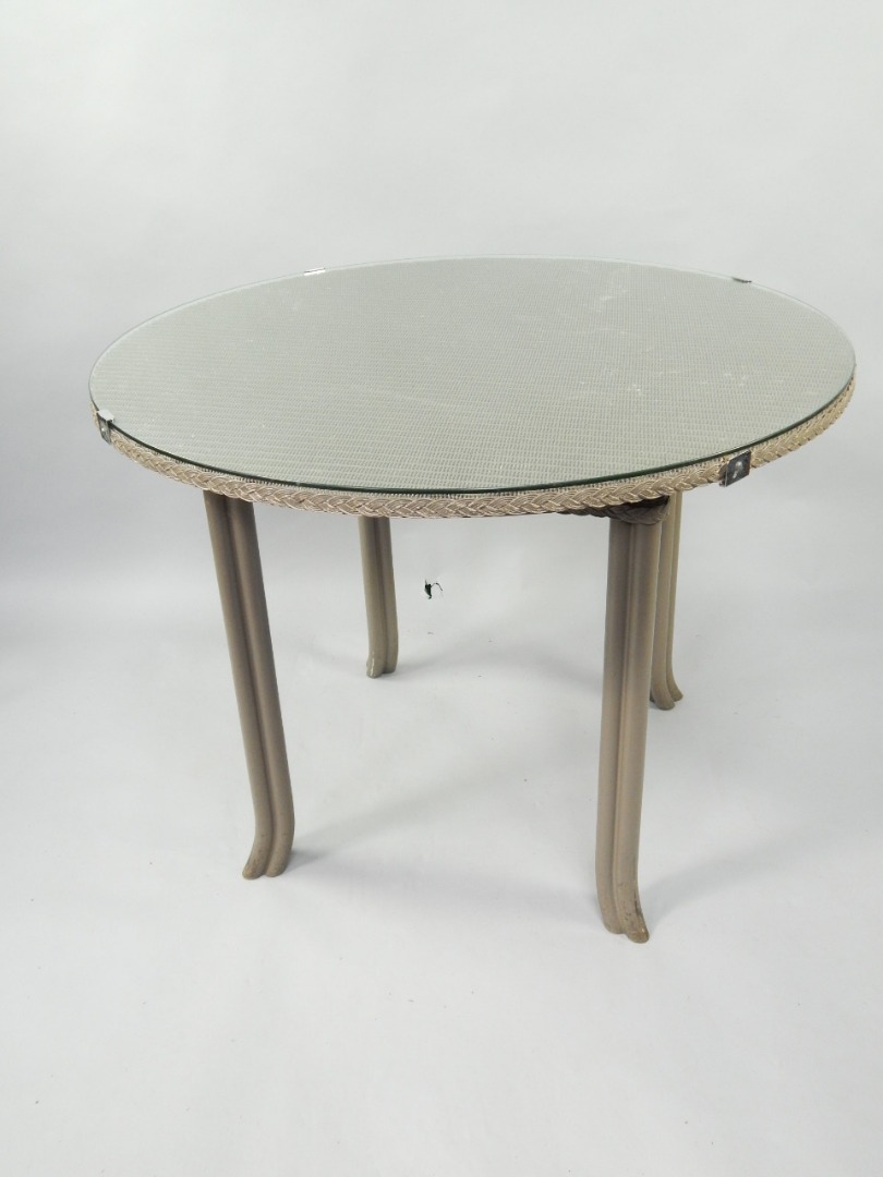 Appraisal: A Lloyd Loom circular table with plate glass top cm