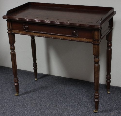 Appraisal: A William IV mahogany table with three-quarter gallery fitted a