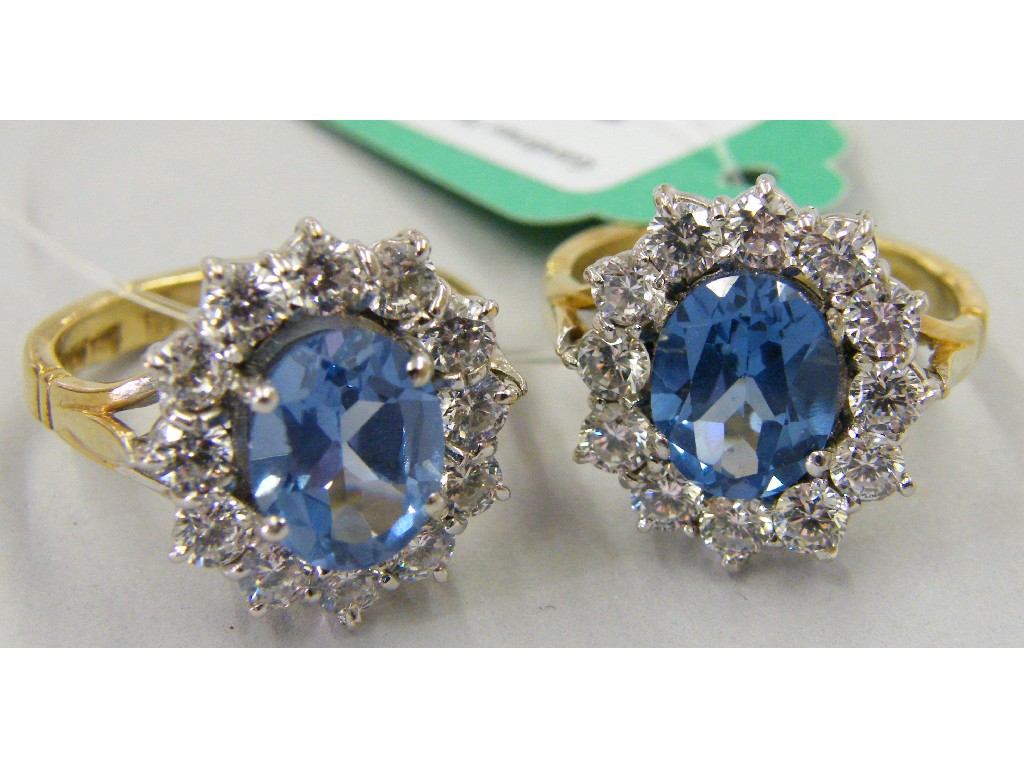 Appraisal: Two similar large ct blue stone and cz cluster rings