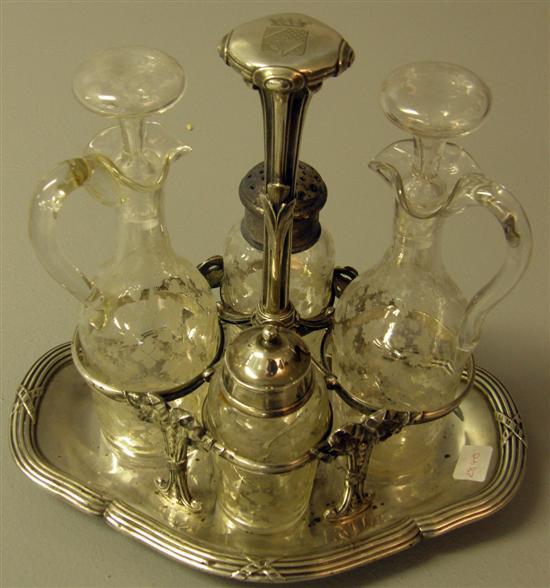 Appraisal: French white metal cruet stand with four compartments on ribbon-tie