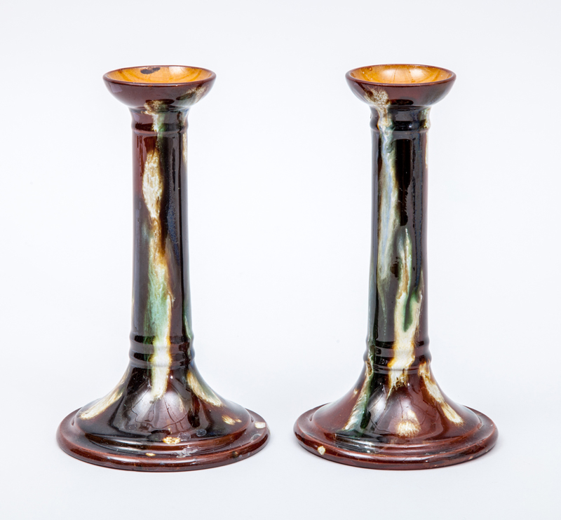 Appraisal: AESTHETIC MOVEMENT PAIR OF CANDLESTICKS Glazed terracotta unmarked x in