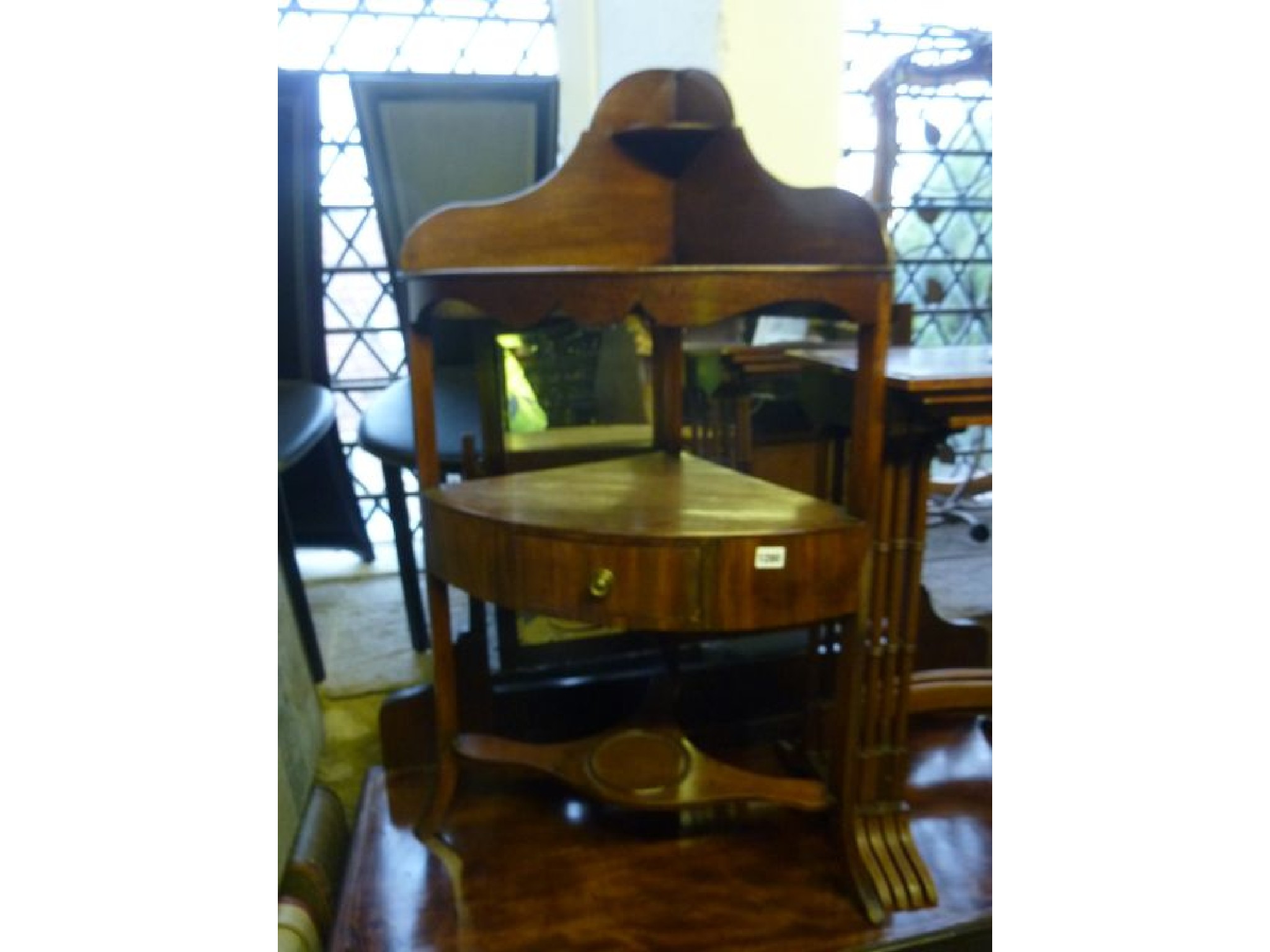 Appraisal: A Georgian mahogany corner washstand in three tiers