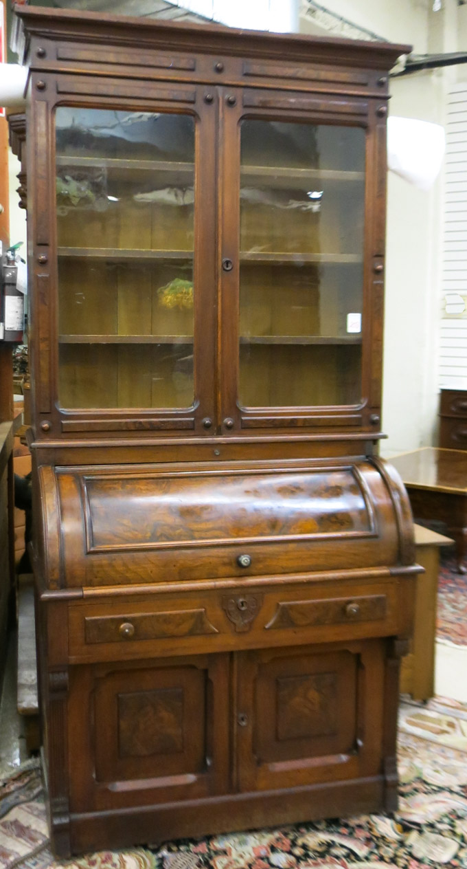 Appraisal: A VICTORIAN WALNUT CYLINDER-ROLL SECRETARY BOOKCASE American th century having