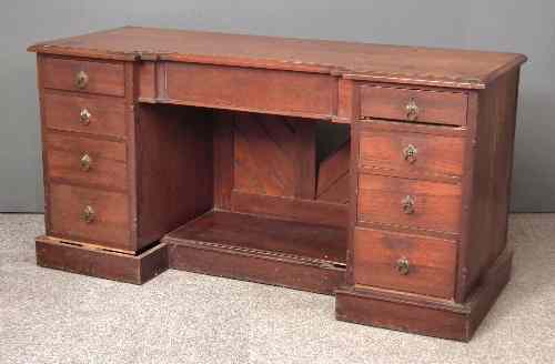 Appraisal: A hardwood kneehole dressing table with recessed centre fitted nine