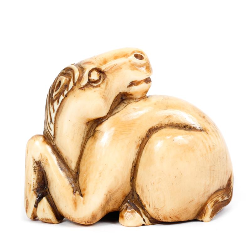 Appraisal: Japanese carved ivory netsuke reclining horse figure marked on bottom