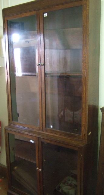 Appraisal: A th century oak display cabinet the pair of glazed