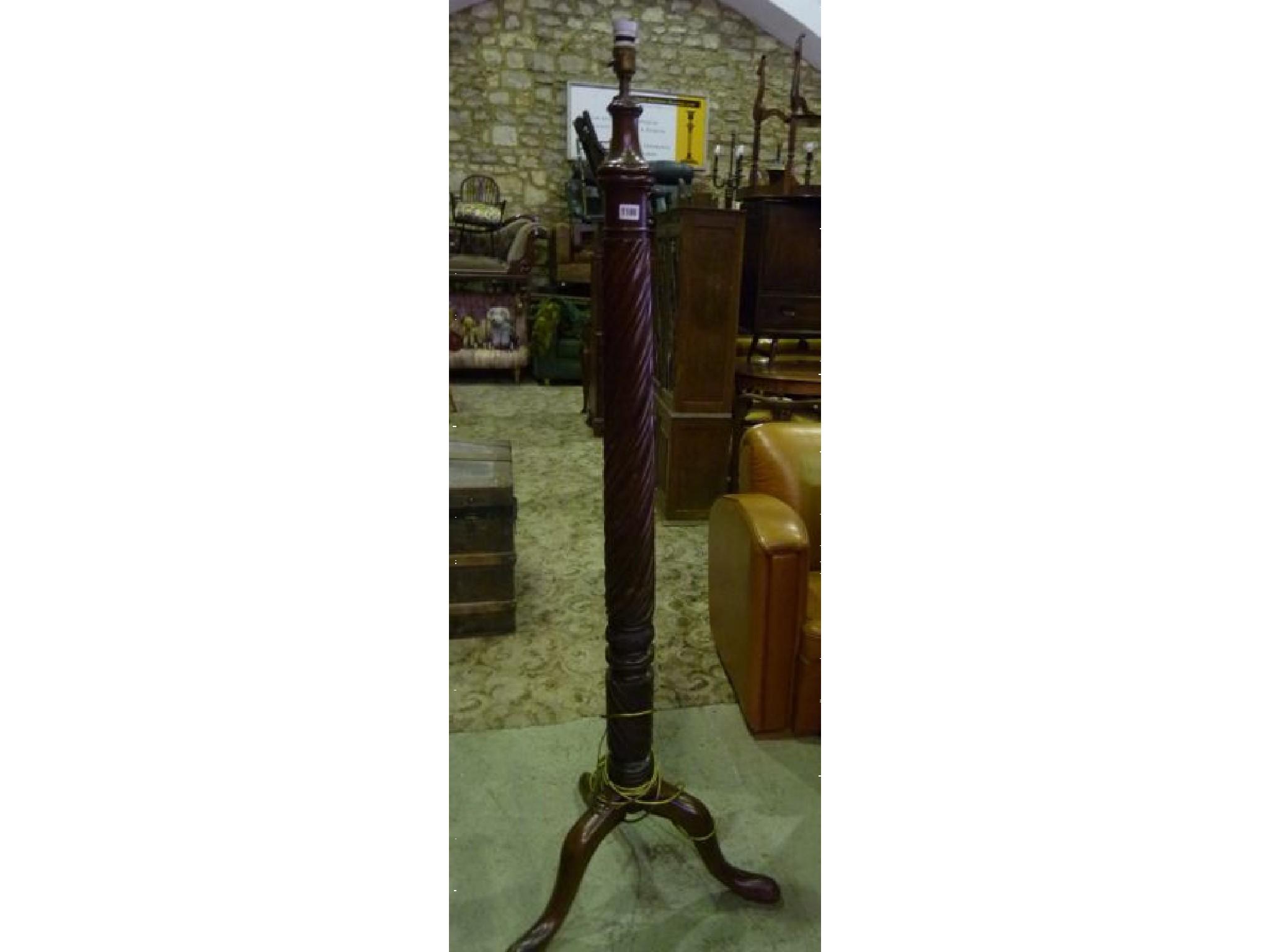 Appraisal: A mahogany standard lamp with rope twist column and shaped