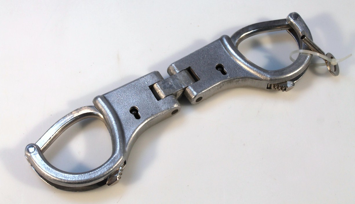 Appraisal: A pair of thC East German metal handcuffs with fixed