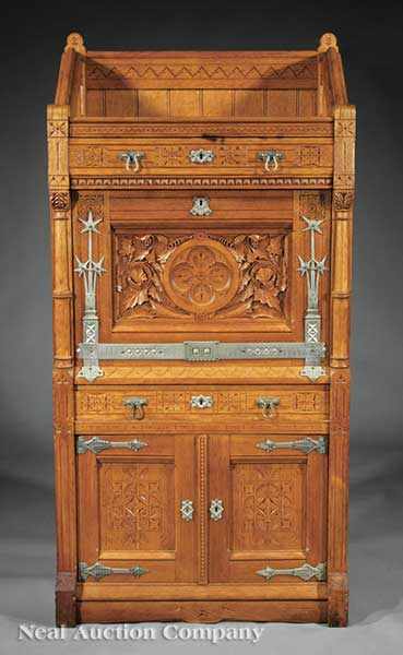 Appraisal: An American Aesthetic Carved Oak S cr taire Abattant late