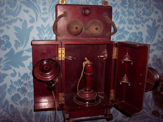 Appraisal: A wall mounted mahogany cased telephone with turned wooden receiver