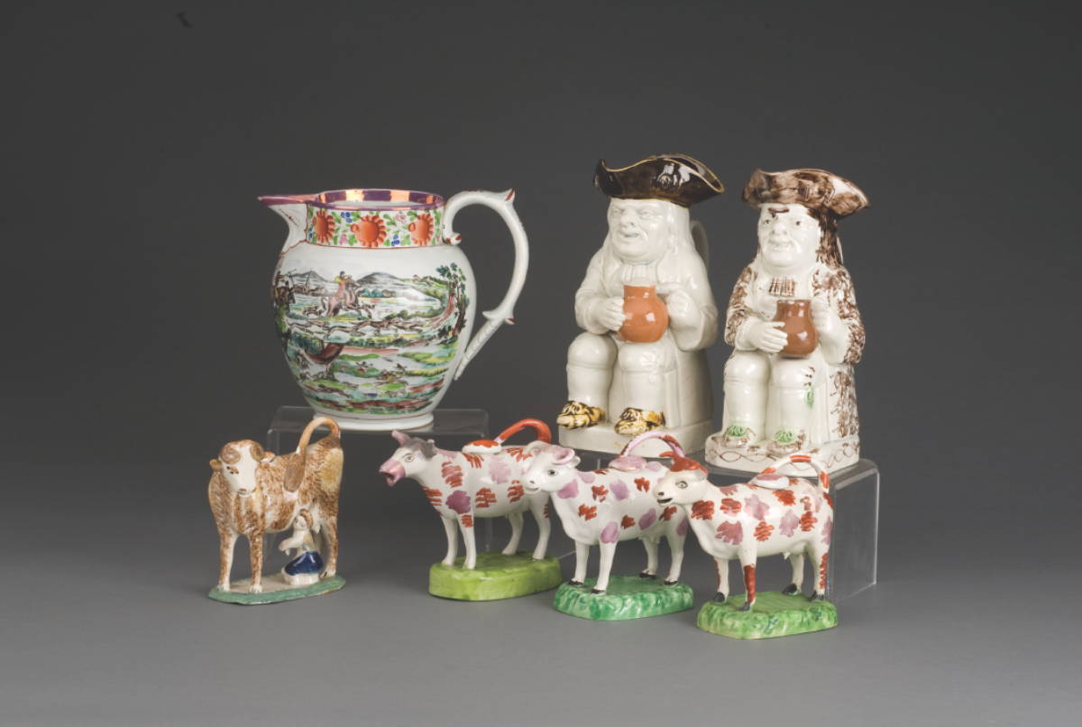 Appraisal: THREE BRITISH POTTERY ENAMEL AND LUSTRE-DECORATED COW CREAMERS AND COVERS