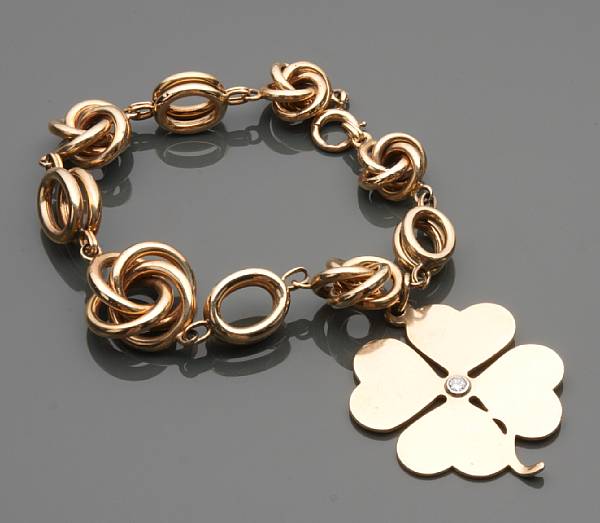 Appraisal: A k gold charm bracelet with one four leaf clover