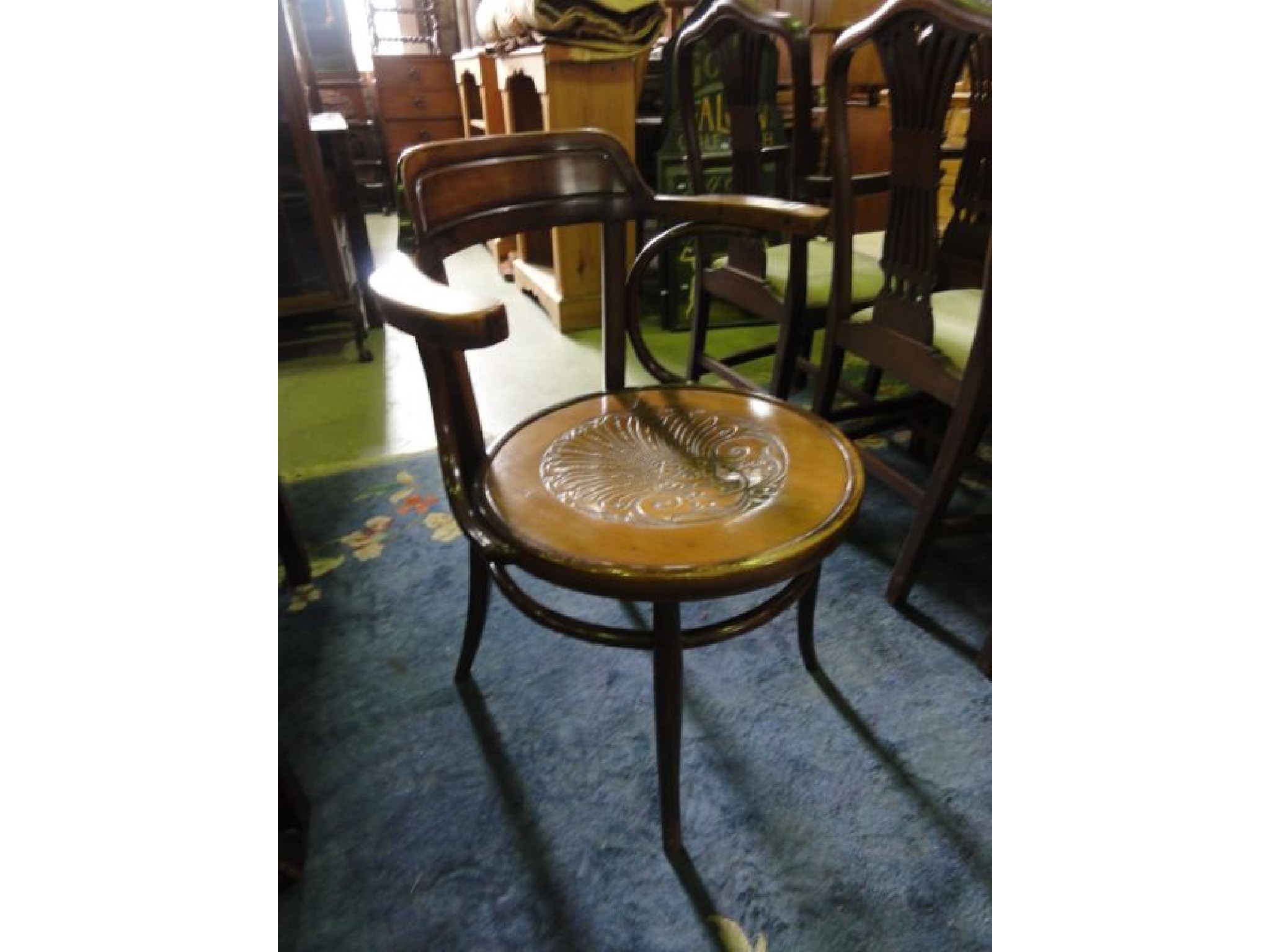 Appraisal: A vintage bentwood elbow chair with circular pressed shell patterned