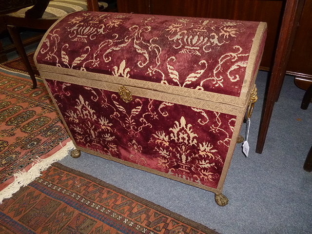 Appraisal: A RED VELVET UPHOLSTERED DOME TOPPED CASKET with lion ring