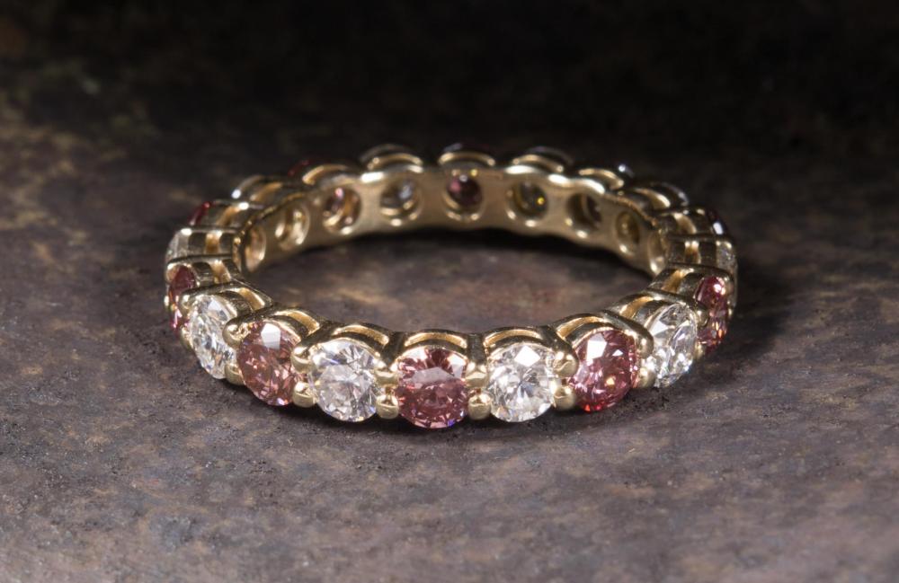 Appraisal: PINK AND WHITE DIAMOND ETERNITY RING The k yellow gold