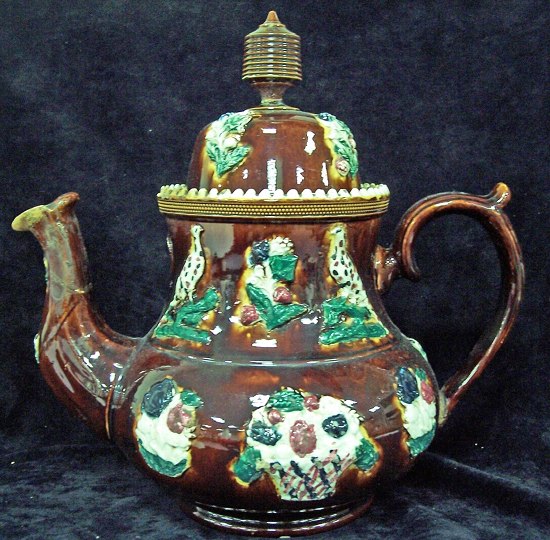 Appraisal: A barge ware type brown glaze teapot cm high