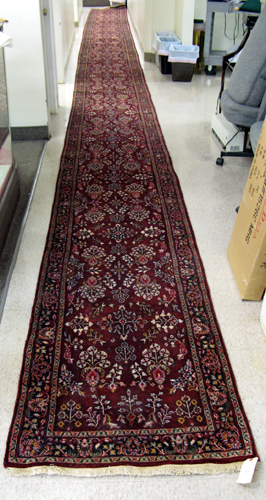 Appraisal: AN EXTRA LONG INDO-SAROUK RUNNER hand knotted in an overall