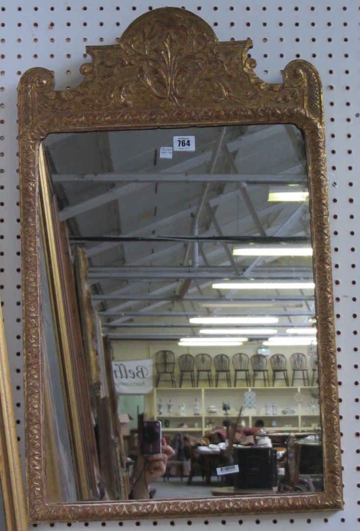 Appraisal: An th century gilt framed wall mirror the relief floral