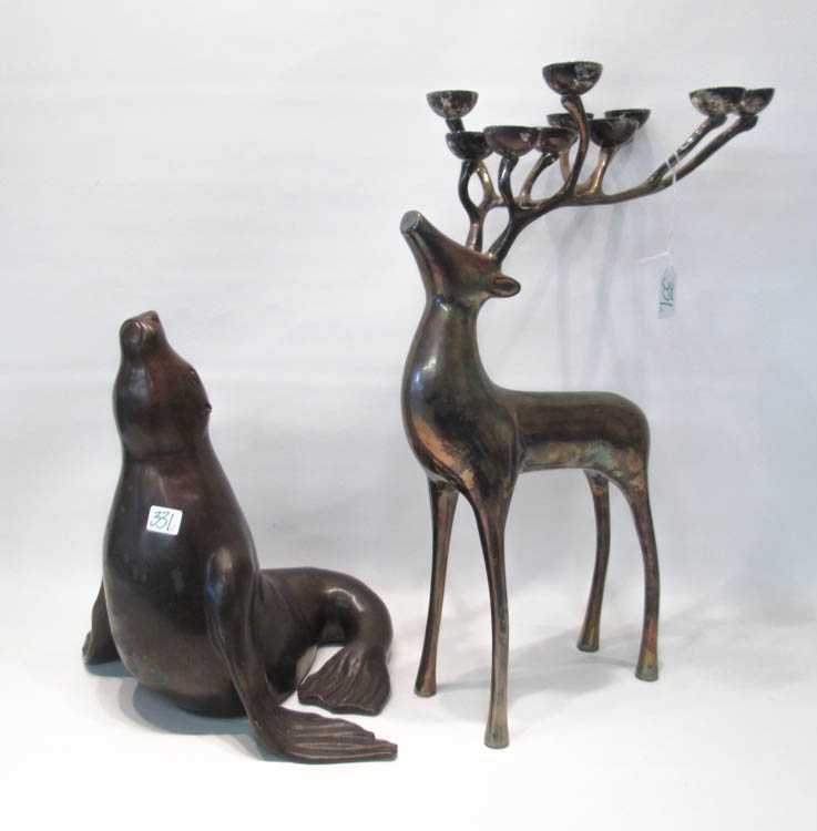 Appraisal: TWO CAST METAL FIGURAL SCULPTURES patinated bronzed seal together with