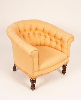 Appraisal: A Victorian tub-shaped armchair with deep buttoned back on turned