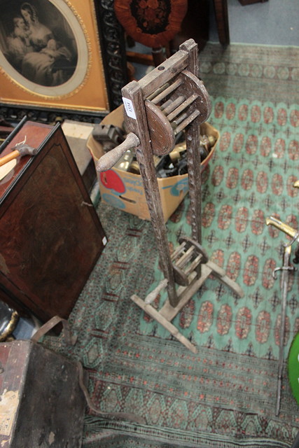 Appraisal: AN OLD OAK WOOL WINDER with two adjustable spindles standing