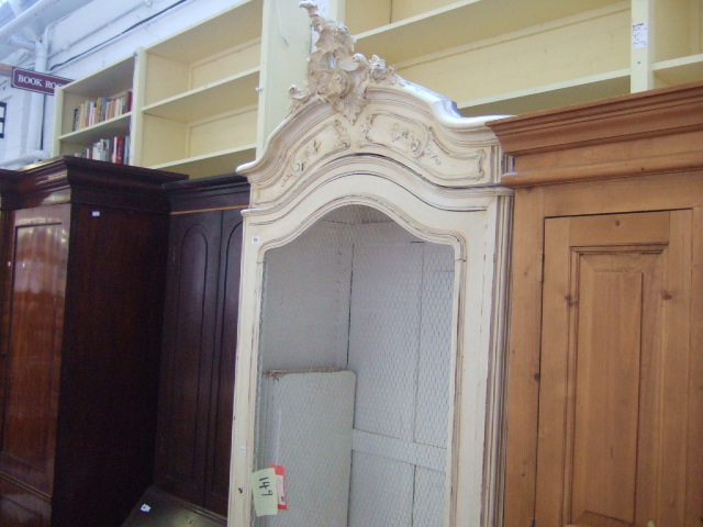 Appraisal: A late th century cream painted armoire the carved cornice