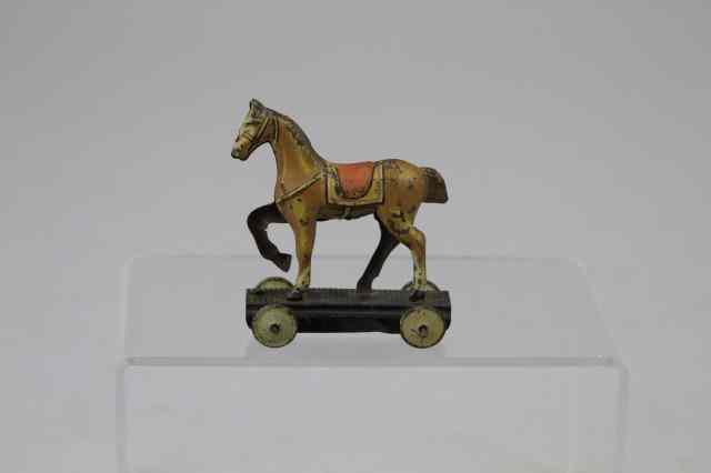 Appraisal: HORSE PENNY TOY Germany lithographed tin prancing horse with red